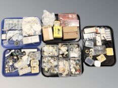 A large quantity of horologist parts and spares, movements, dials, watch crystals, springs, pins,