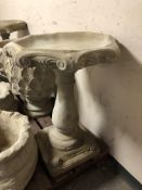 A concrete octagonal garden bird bath,