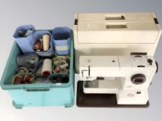 A Pfaff synchromatic 1217 electric sewing machine, in box, and a box of spools of thread.