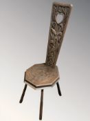 An Arts and Crafts carved oak spinning chair, height 101 cm.