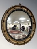 A gilt convex wall mirror,