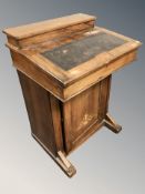 A Victorian figured walnut and satin inlaid Davenport,