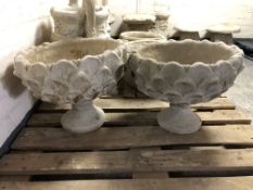 A pair of concrete garden planters,