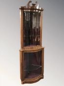 A pair of reproduction mahogany and satinwood inlaid serpentine front corner cabinets,