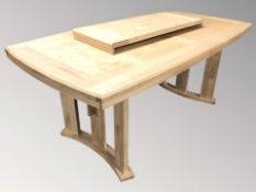 A modern oak extending dining table with leaf,