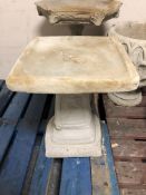 A concrete garden bird bath,