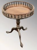 A reproduction mahogany circular tripod table with galleried top, on claw and ball feet,