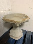A concrete garden hexagonal bird bath,
