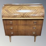 A 1970's teak cylinder front bureau, 91 cm W x 50 cm D x 97 cm H.
