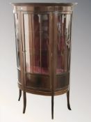 A reproduction mahogany and satinwood inlaid bow front display cabinet,
