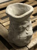 A concrete toby jug planter,