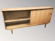 A 20th century teak sliding door low bookcase,
