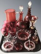 A group of cranberry glass including two decanters, hand painted vase, jug, set of six glasses,