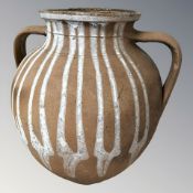 A terracotta twin handled vessel, height 34 cm.