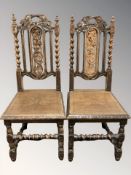 A pair of heavily carved oak barley twist chairs.