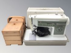 A Singer electric sewing machine and a Concertina sewing box.