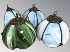 Three Tiffany-style coloured glass light shades and a further similar wall light.