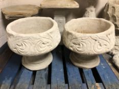 A pair of concrete garden planters,