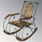 A modern eastern hardwood and metal framed rocking chair.