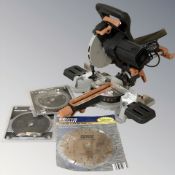 An Evolution compound mitre saw and several blades.