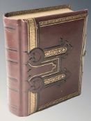 A decorative early 20th century gilt and tooled Burgundy leather photograph album, 16 cm x 14 cm.