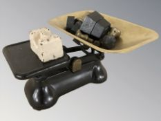 A set of enameled metal scales and various weights.