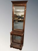 A reproduction mirror backed hall stand,