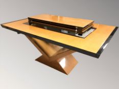 An Art Deco style birch veneered and ebonised high gloss extending dining table.