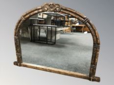 A reproduction carved wooden over mantel mirror, width 99 cm.
