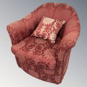 A 20th century armchair in burgundy upholstery,