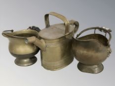 A brass watering can, height 23 cm, and two miniature coal helmets.