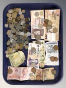 A group of foreign bank notes and assorted coins.