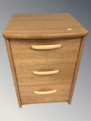 A modern teak effect three drawer chest,