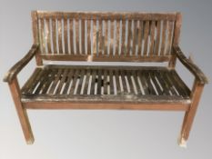 A weathered teak garden bench,
