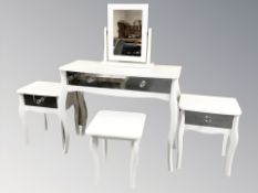 A modern white dressing table with mirror back and stool,