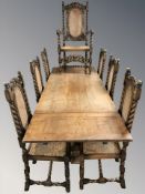A reproduction oak pull out extending refectory dining table on carved bulbous supports,