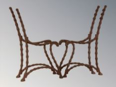 Two pairs of cast iron rustic bench ends.