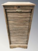 An early 20th century oak tambour front pedestal cabinet, 50 cm W x 42 cm D x 110 cm H.