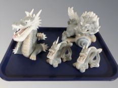 A group of Spanish graduated dragon ornaments and a further temple dog figure.