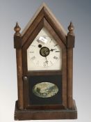 A 19th century American mantel clock by the Waterbury Clock Company, with pendulum and key,