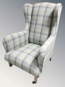 A modern wingback armchair in tartan fabric, width 76 cm.