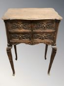 A carved oak four drawer chest on pad feet, width 50 cm.