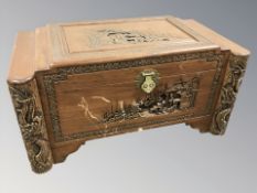 An oriental carved camphor wood blanket box, 94 cm W x 50 cm D x 48 cm H.
