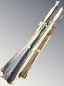 A group of vintage fishing rods in canvas slip covers.