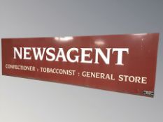 A Newsagent enameled metal sign, 220 cm x 60 cm.