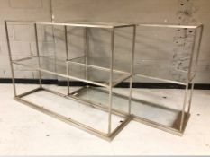 A pair of metal and glass shelves,