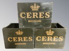 Three painted pine Ceres bottle crates, width 47 cm.