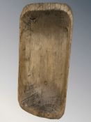 A large 19th century rustic pine dough board, length 94 cm.