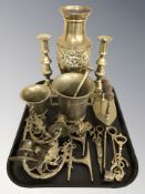 A pair of brass candlesticks, mortar and pestle, vase,