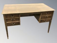 A 20th century Danish teak twin pedestal desk, 127 cm W x 70 cm D x 75 cm H.